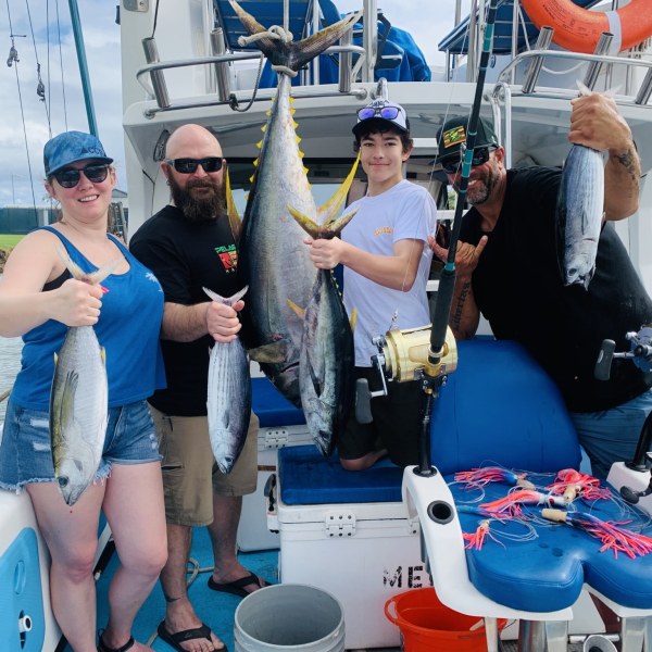 a group of people standing on a boat