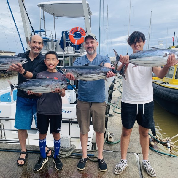 a group of people on a boat posing for the camera