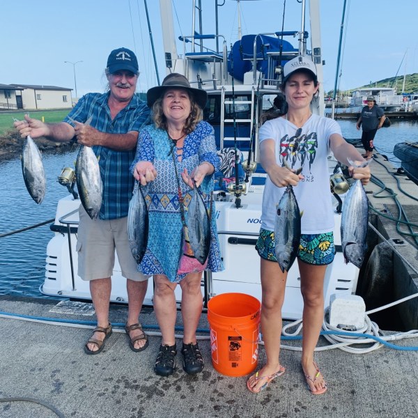 a group of people standing on a boat