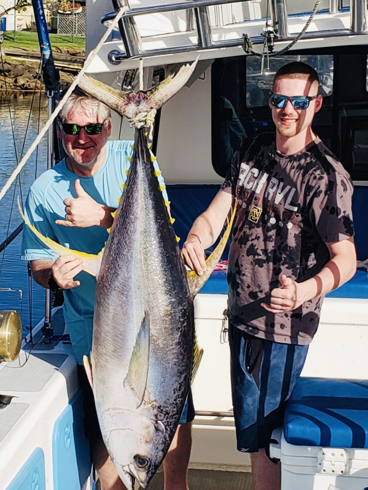 a man holding a fish on a boat