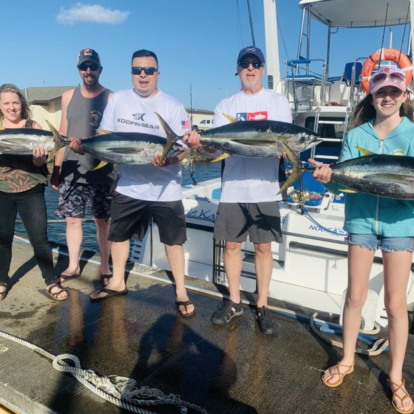 a group of people standing on a boat