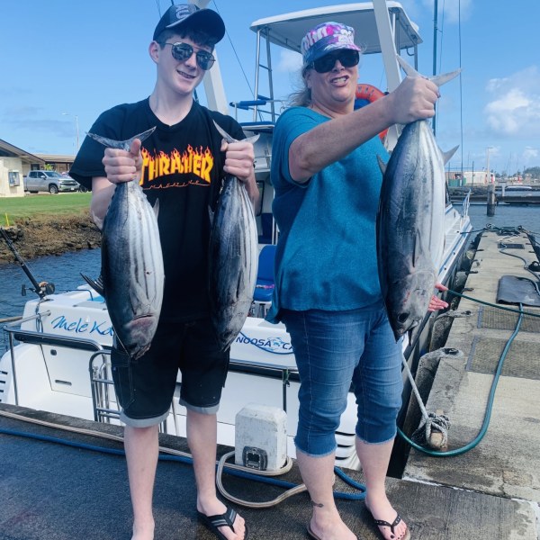 a man and a woman holding a fish