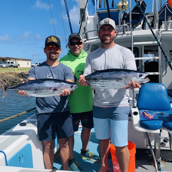 a group of people standing on a boat
