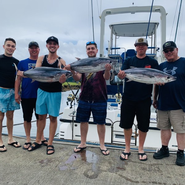 a group of people standing in front of a crowd posing for the camera