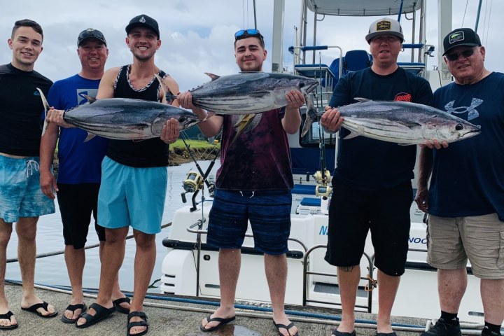 a group of people standing in front of a crowd posing for the camera