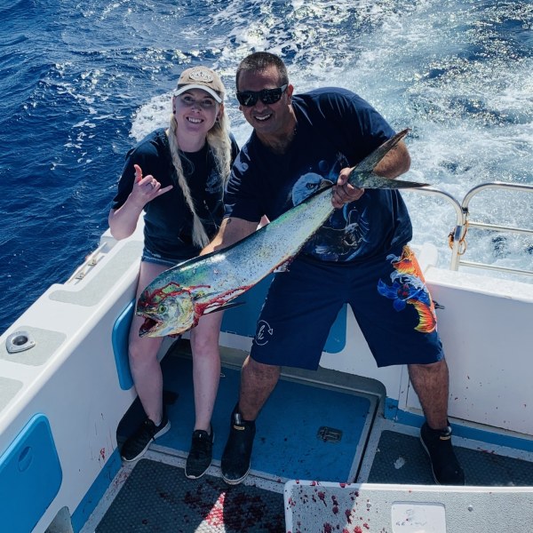 a group of people on a boat posing for the camera