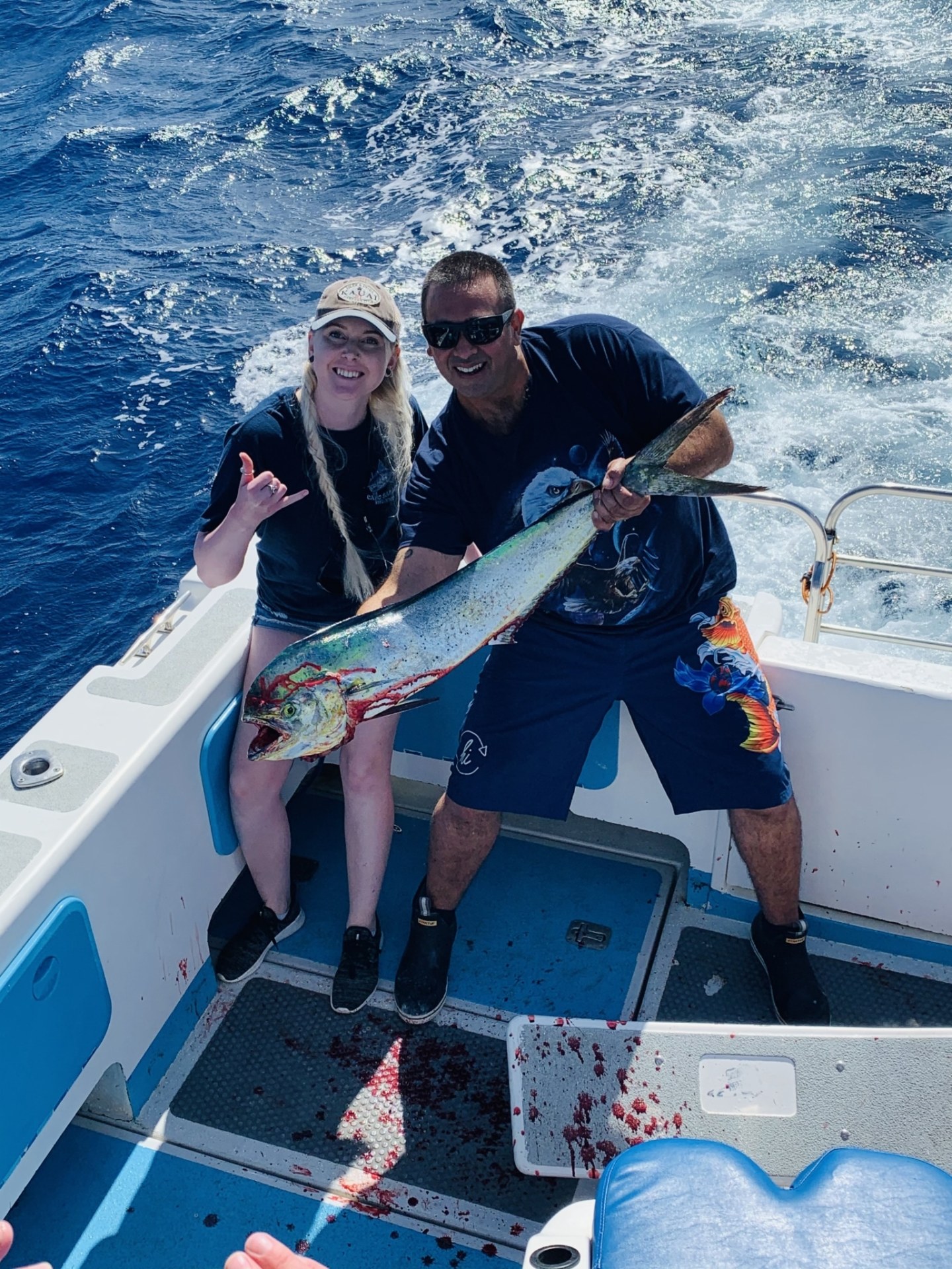 a group of people on a boat posing for the camera