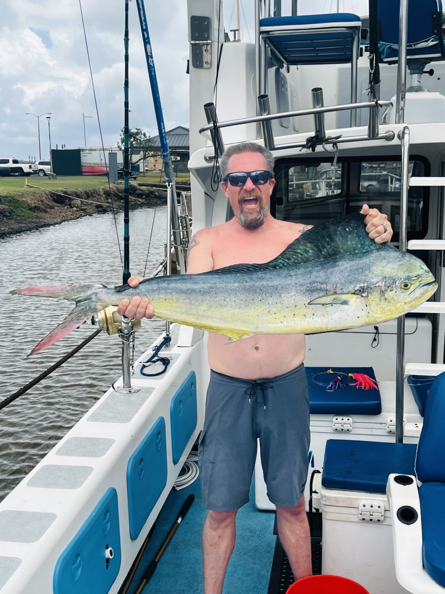 a man holding a fish on a boat
