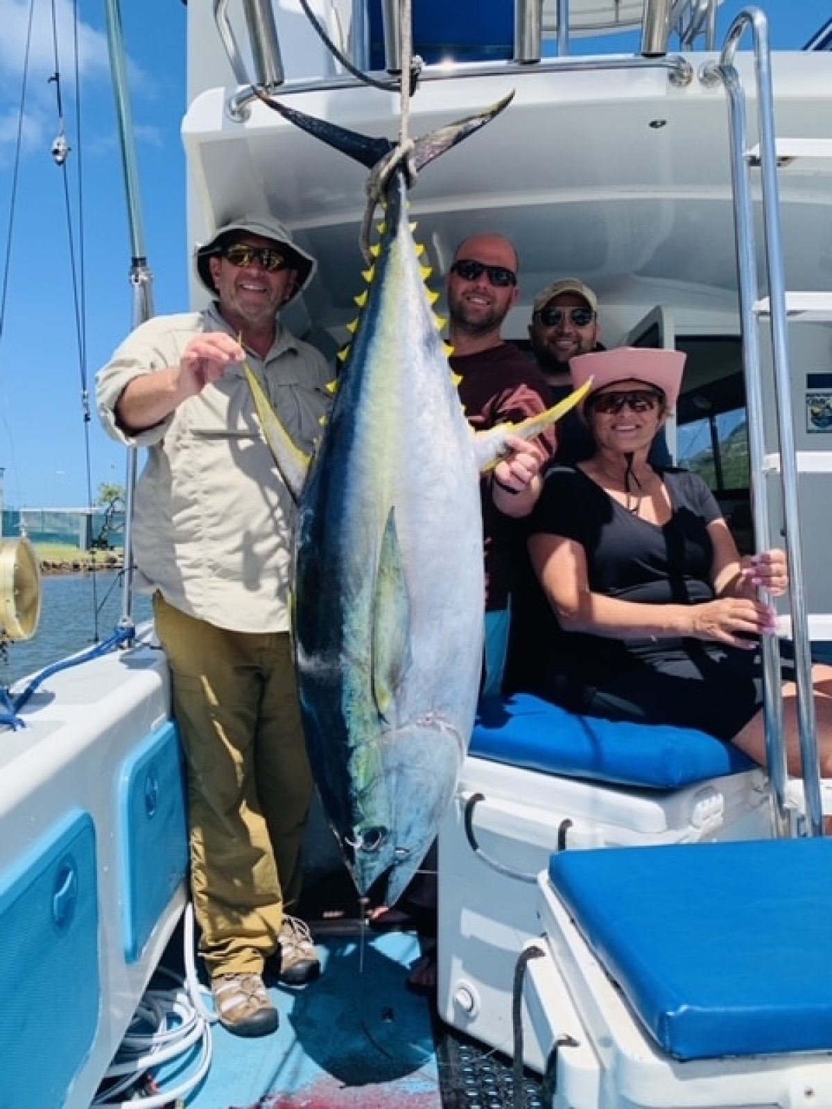 a man holding a fish on a boat