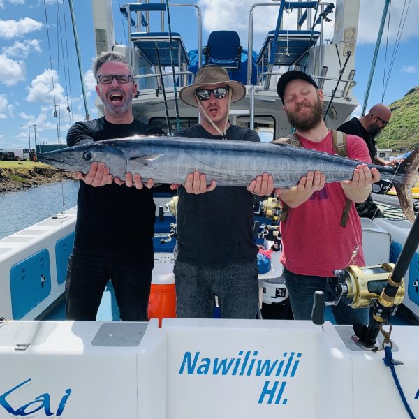 a man holding a fish on a boat