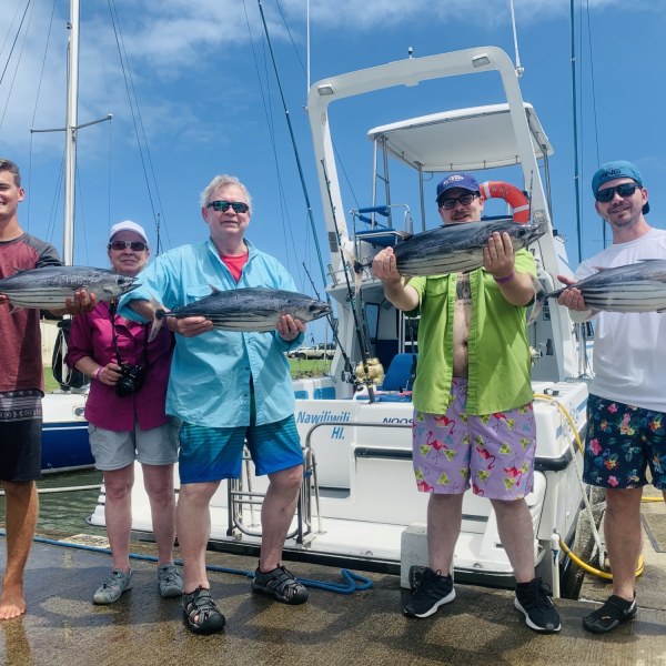 Peyton Meyer et al. standing on a boat posing for the camera