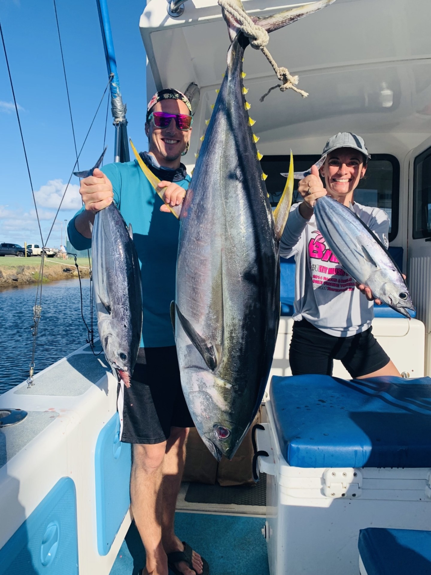a man holding a fish on a boat