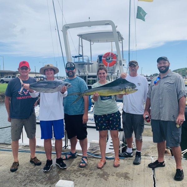 a group of people standing in front of a crowd posing for the camera